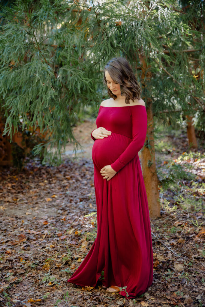 Mom wearing stylish, affordable maternity clothes in woods